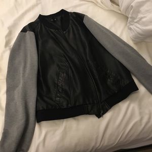 Faux leather  with grey sleeves.Torrid size 2